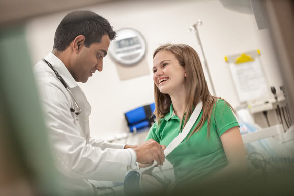 Physician consulting with patient in a clinical environment, highlighting care, trust, and communication.